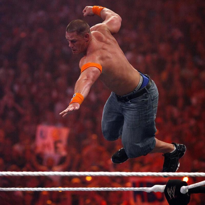 WWE Superstar John Cena leaps off top rope against Batista
