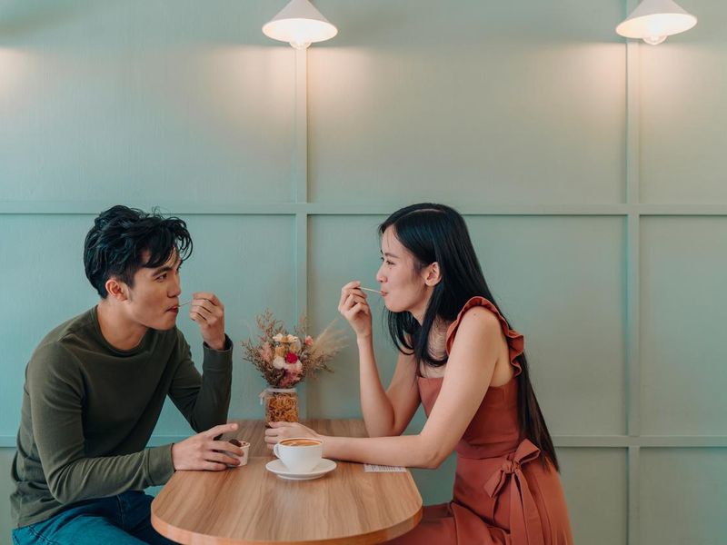 Young couple locking eyes in a cafe