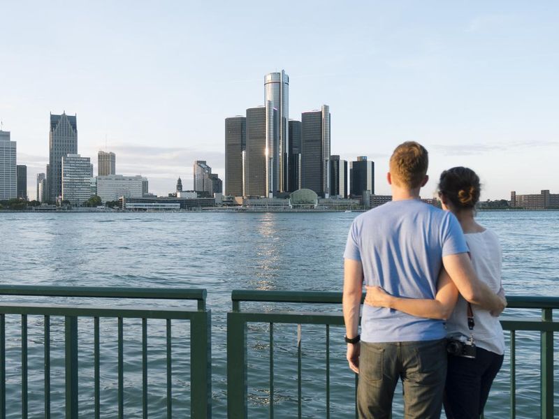 Young couple looking at Detroit skyline