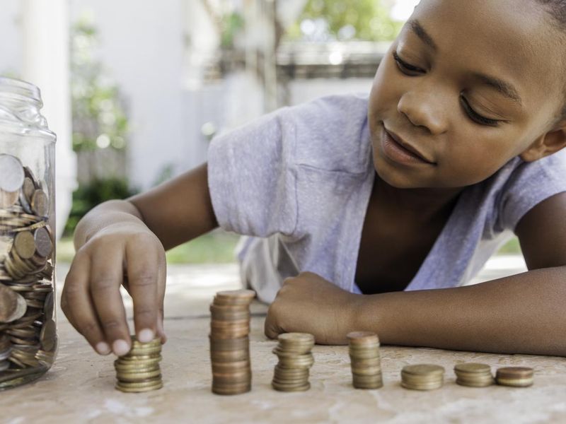 Young girl counting her coins