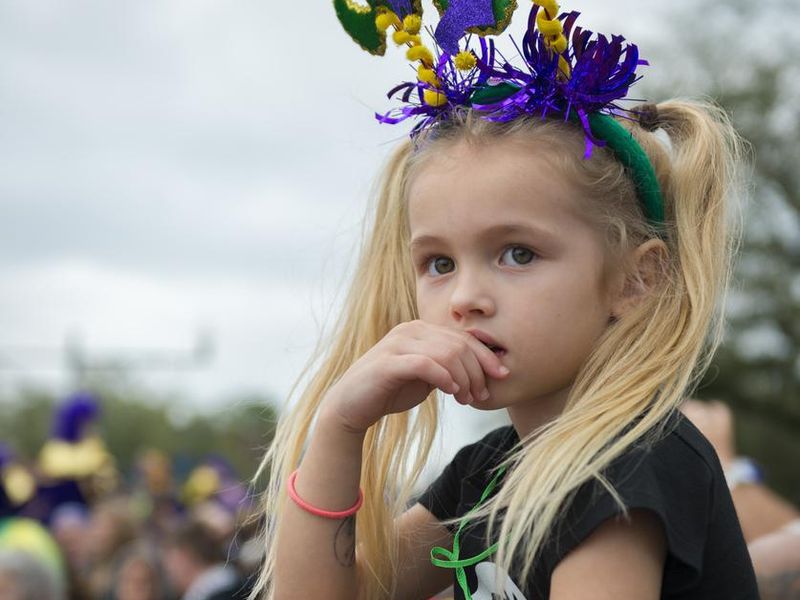 Young girl watching Mardi Gras parade