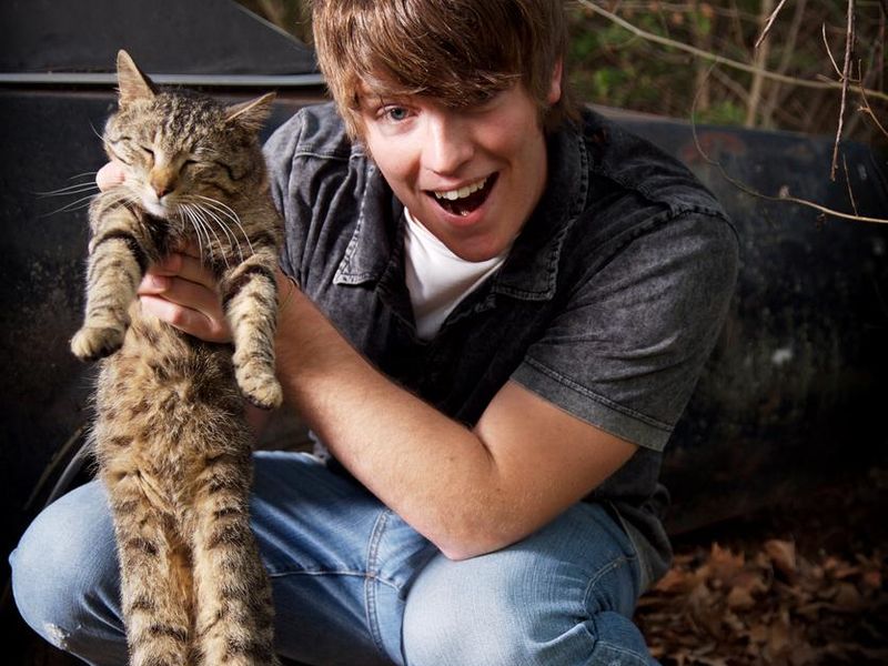 Young man holding a cat
