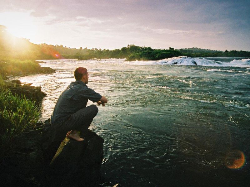 Young Man staring at the Source of the River Nile