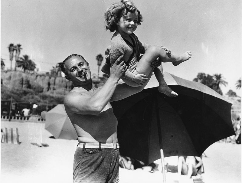 Young Shirley Temple with Dad at the Beach