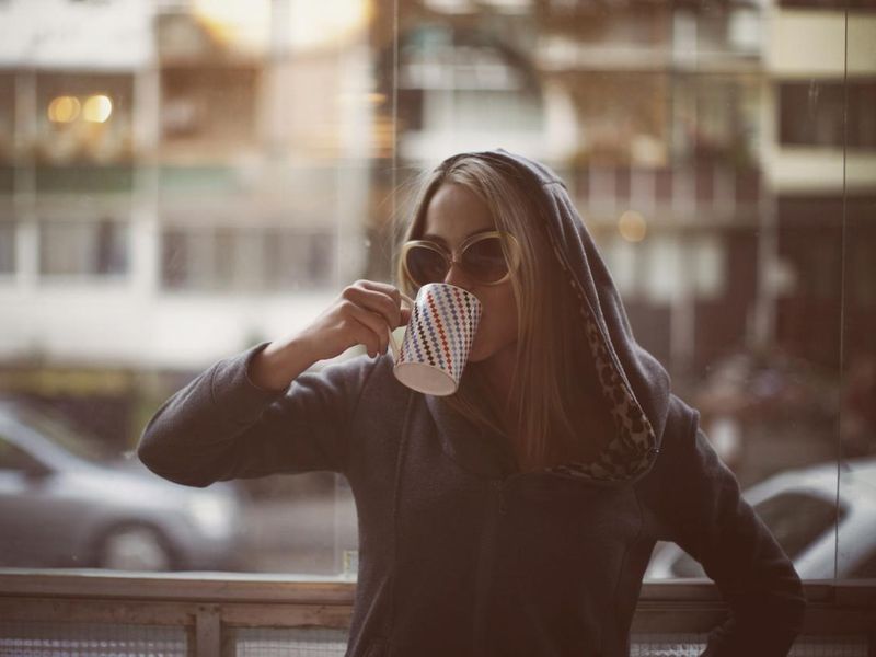 Young woman drinking late morning coffee