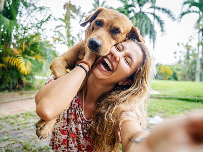 Young Woman Takes Selfie With Her Dog