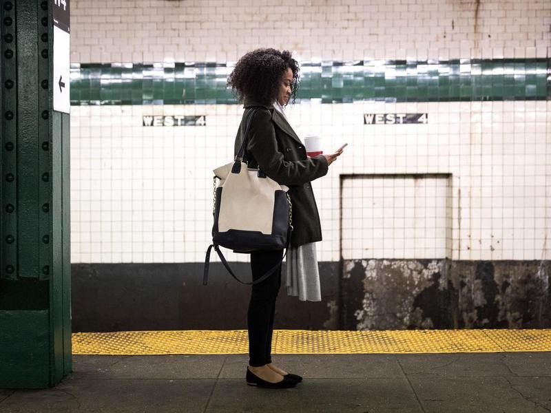 Young woman waiting for the subway train in New York