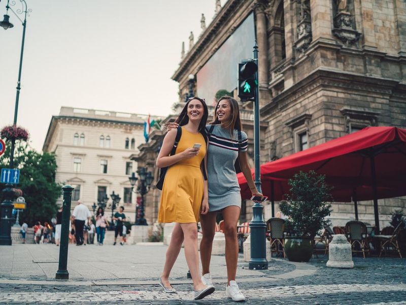 Young women in Budapest crossing the street